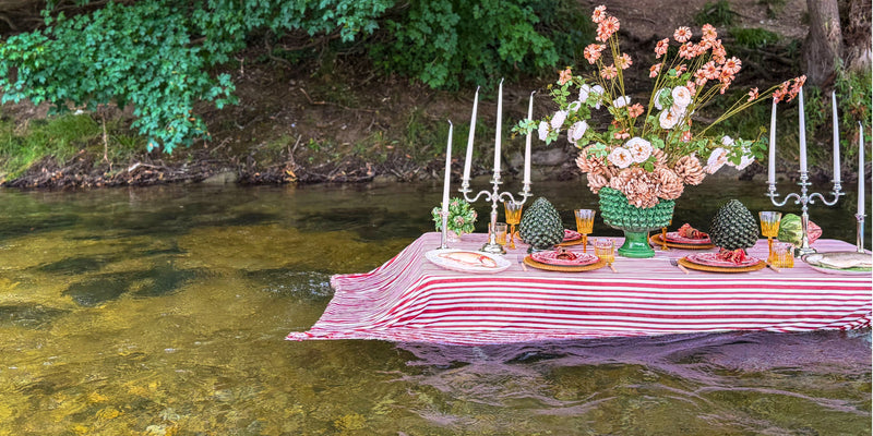 Rustikale Tischdeko im Riverside Look mit gestreifter Tischdecke, Keramik-Geschirr und Kerzenständern auf einem Tisch im Münchner Flusslauf von Table Desires.